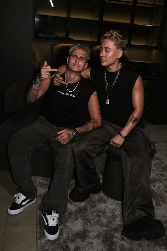 two friends on a lounge couch mid-conversation