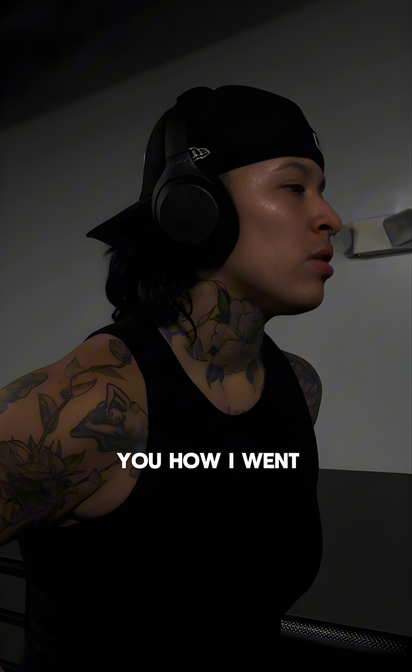 Person wearing headphones with text 'YOU HOW I WENT' on a dark background